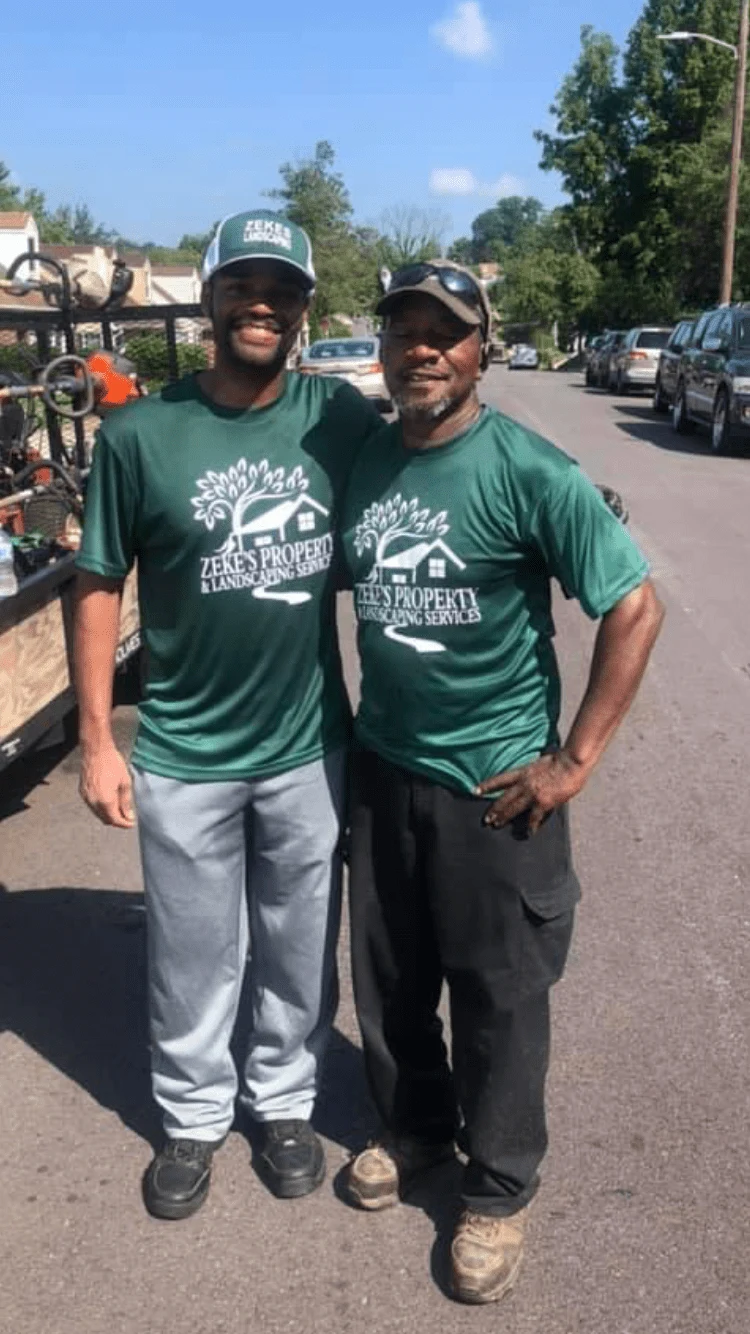 Two members of the Zeke’s PP Landscaping team in their green work shirts